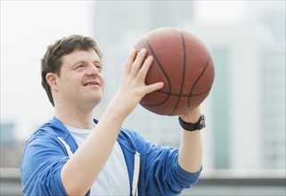 Man with down syndrome playing basketball.