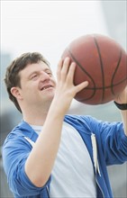 Man with down syndrome playing basketball.