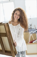 Young female artist in studio.