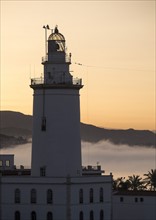 Malaga, Lighthouse at sunset. Malaga, Spain.
