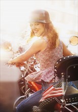 Young woman riding motorcycle.