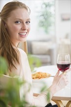 Woman having meal with red wine