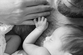 Father holding newborn daughter