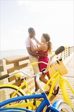 Young couple embracing on boardwalk