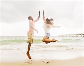 Young couple playing on beach