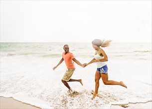 Young couple running on beach