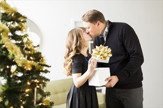 Woman and man kissing at Christmas