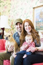 Portrait of family with one child (2-5 months) and French bulldog
