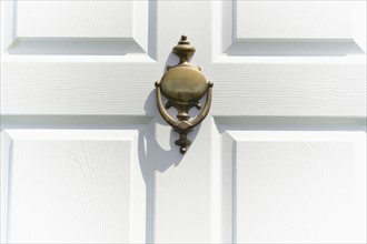 Close-up of white door with knocker