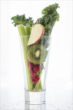 Studio shot of fruits and vegetables in glass.