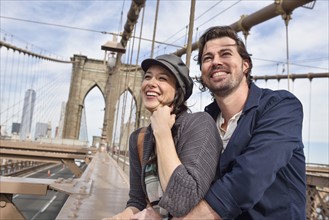 Happy couple on Brooklyn Bridge. Brooklyn, New York.