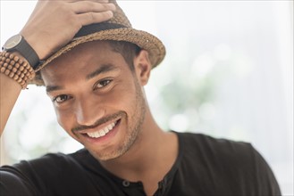 Portrait of smiling man in straw hat.