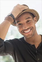 Portrait of smiling man in straw hat.