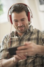 Smiling man listening to music. .