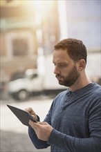 Delivery man using digital tablet.