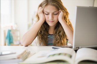 Girl (12-13) doing homework