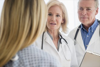Close-up shot of two doctors talking to female patient