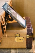 Studio shot of digital tablet on suitcases
