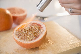 Studio shot of caramelizing sugar on grapefruit slice