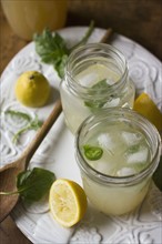 Studio shot of lemonade in jar and glass
