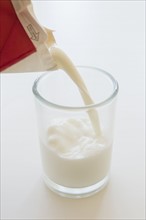 Studio shot of milk pouring into glass