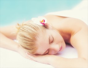 Woman lying next to swimming pool