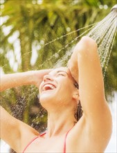 Woman taking shower outdoors