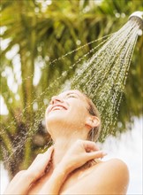 Woman taking shower outdoors