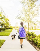 Girl (6-7) walking her dog