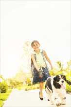 Portrait of girl (6-7) walking her dog