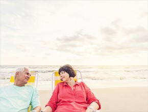 Older couple relaxing on beach
