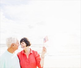 Couple celebrating Fourth of July on beach