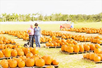 Portrait of couple standing in pumpkin patch