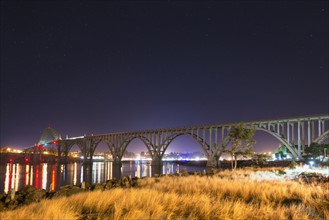 View of arch bridge at night