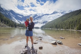 Woman with son (4-5) standing on lakeshore