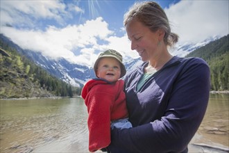 Portrait of woman with son (4-5) on lakeshore
