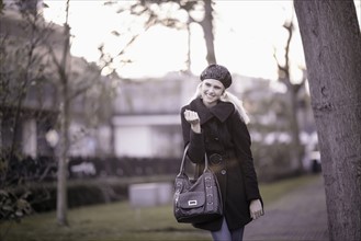 Smiling woman walking in park