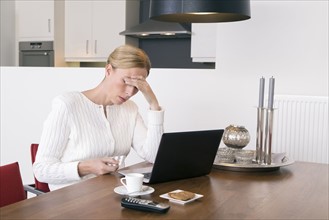 Overworked woman holding pack of tablets
