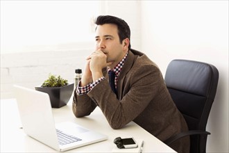 Businessman sitting in office and thinking