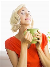 Woman relaxing with cup of coffee