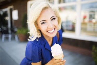 Portrait of smiling woman with ice-cream