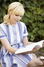 Woman reading book in garden