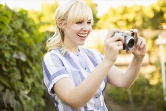 Blonde woman with digital camera