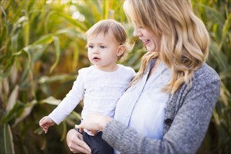 Mother and daughter (12-17 months) in corn field