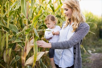 Mother and daughter (12-17 months) in corn field