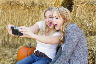 Two friends taking selfie in field