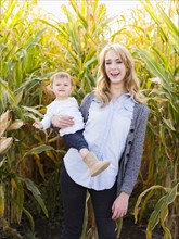 Portrait of mother and daughter (12-17 months) in corn field