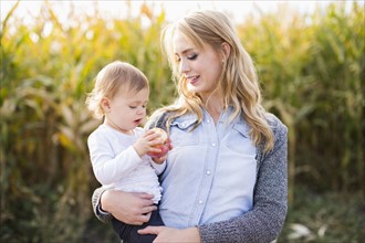 Portrait of mother and daughter (12-17 months) in field