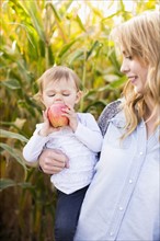 Portrait of mother and daughter (12-17 months) in field