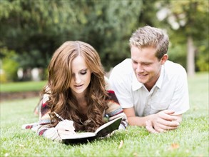 Portrait of couple laying in grass